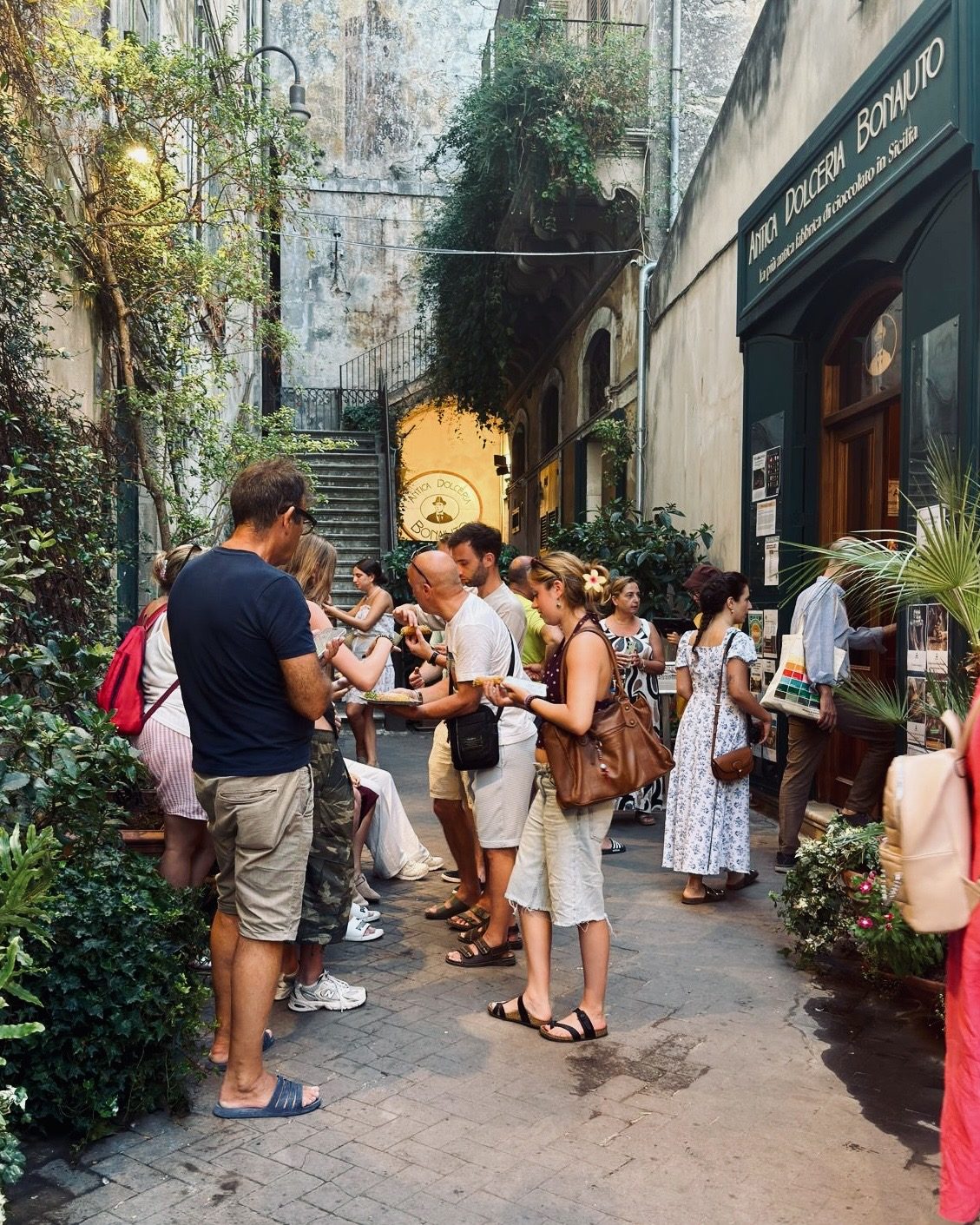 Visitors gathered in the lane outside the Antica Dolceria Bonajuto shopfront in Modica