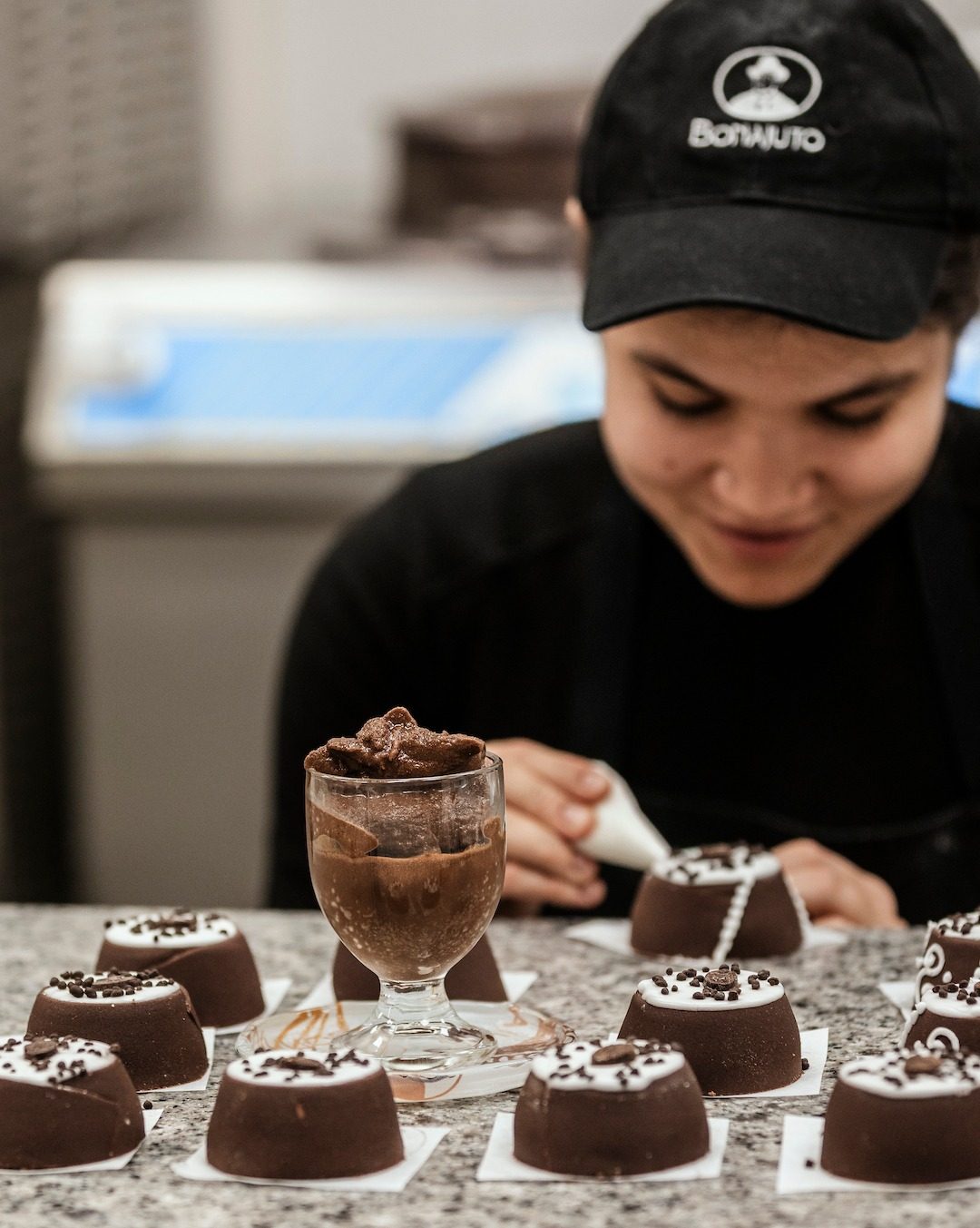 A Bonajuto pastry chef decorating chocolate sweets by hand