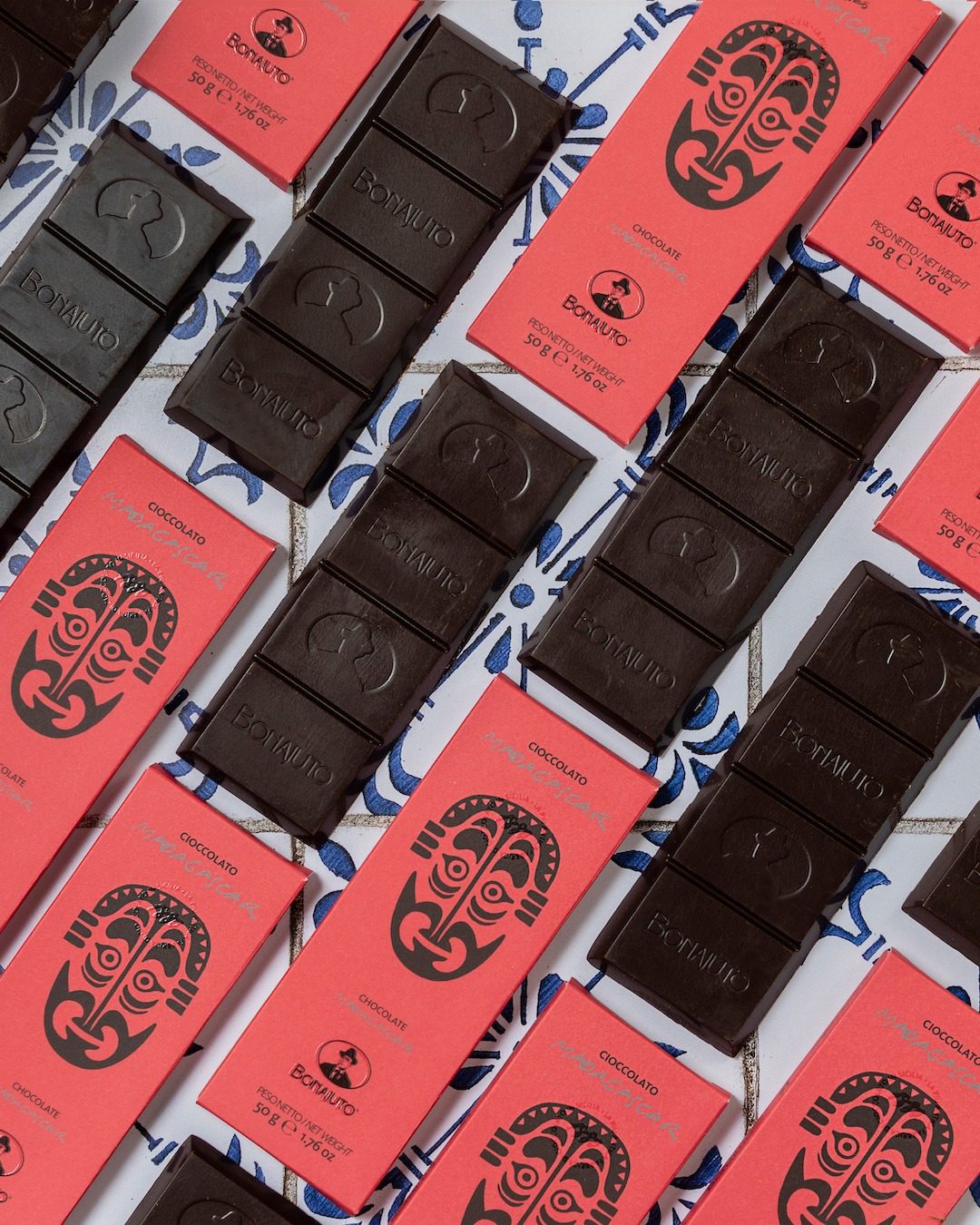 Unwrapped Bonajuto chocolate bars with the house mark pressed into the grainy surface
