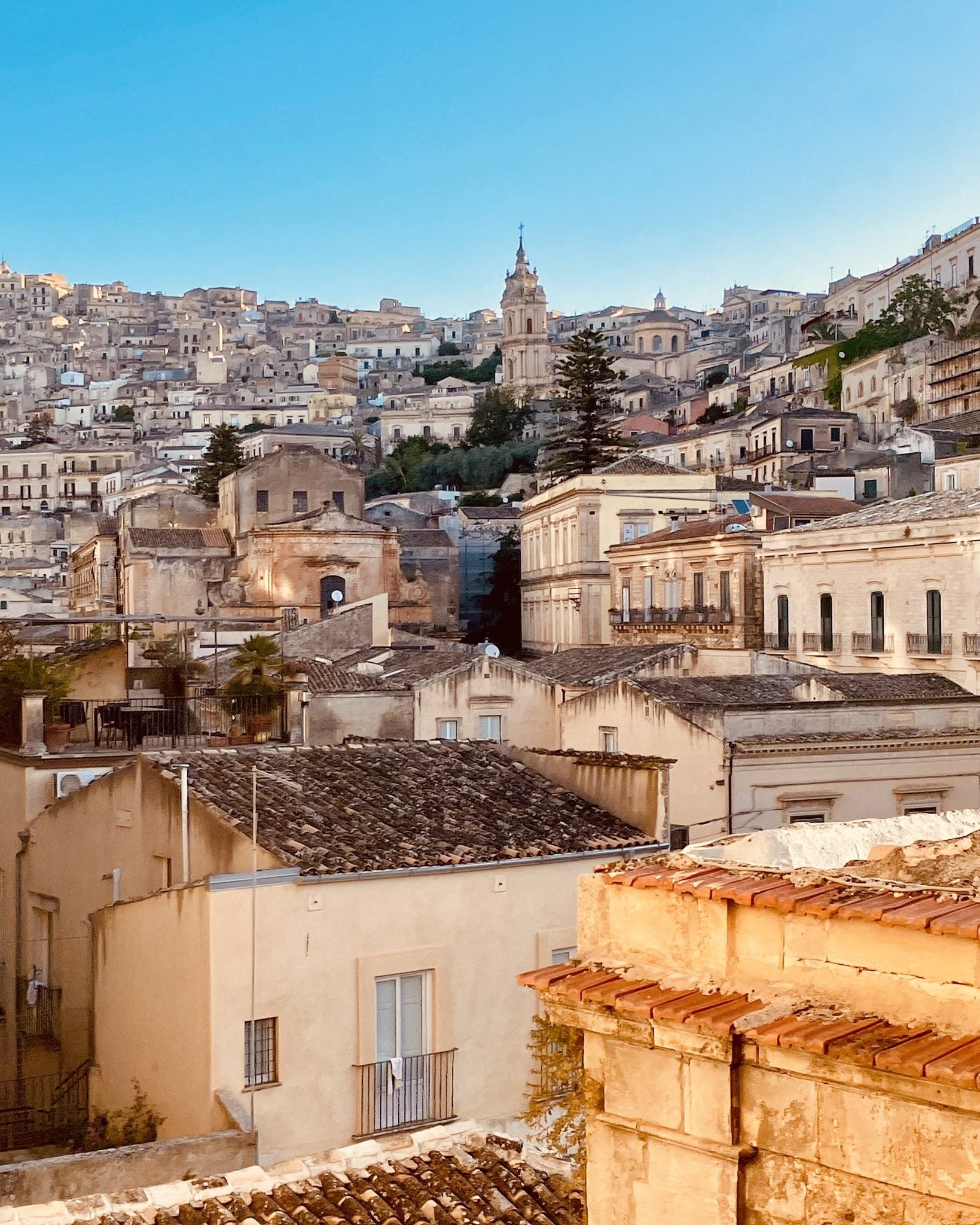 Modica at first light, Baroque houses climbing the gorge around the dome of San Giorgio