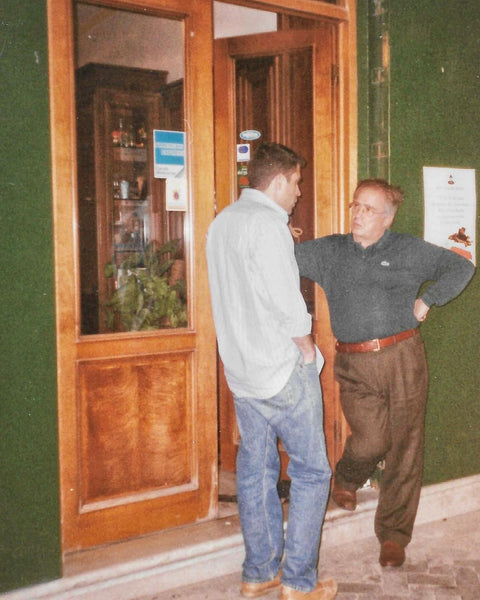 Archival photograph of the Ruta family talking outside the Bonajuto shop in the early 1990s