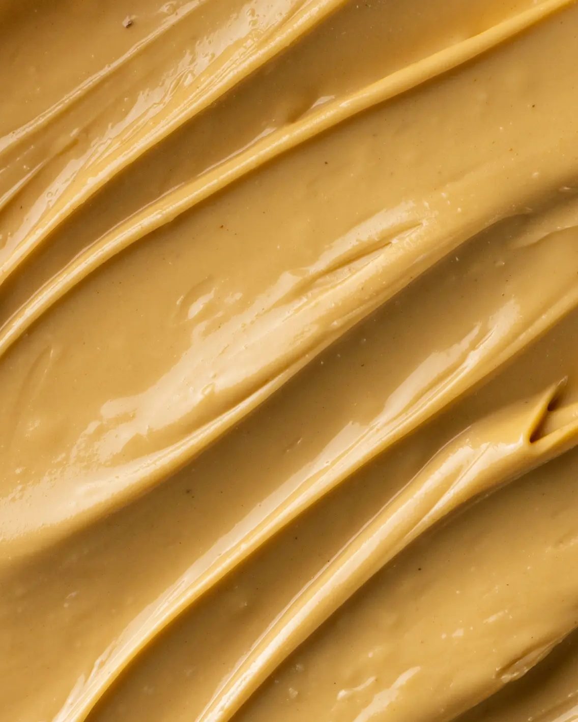 BonCrem nut butter spread in golden ridges, photographed close up.
