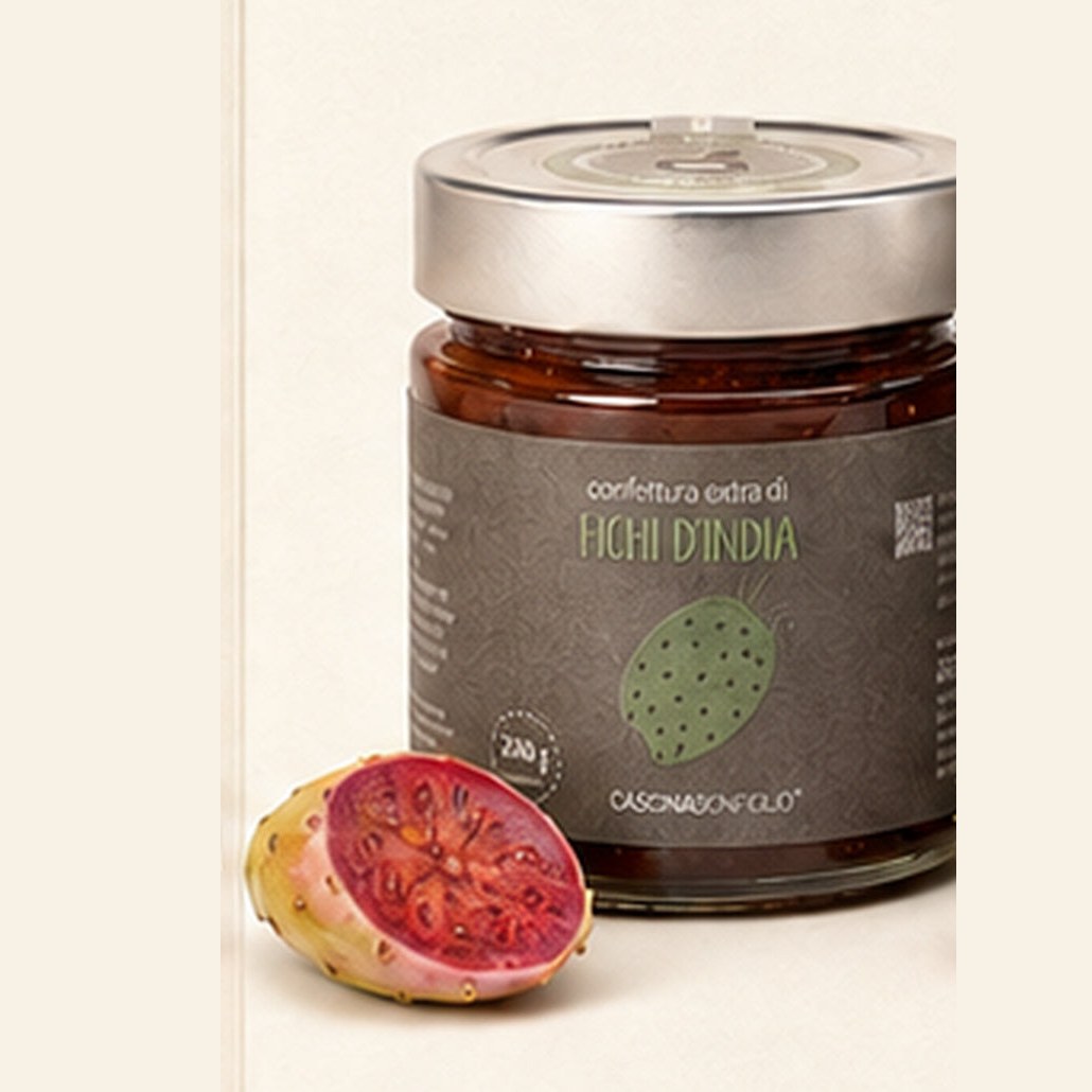 A jar of Cascina Bonfiglio prickly pear extra jam on ivory, the 110% fruit figure printed on the label