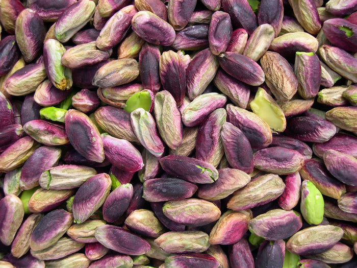 Shelled pistachios, green under their violet skin